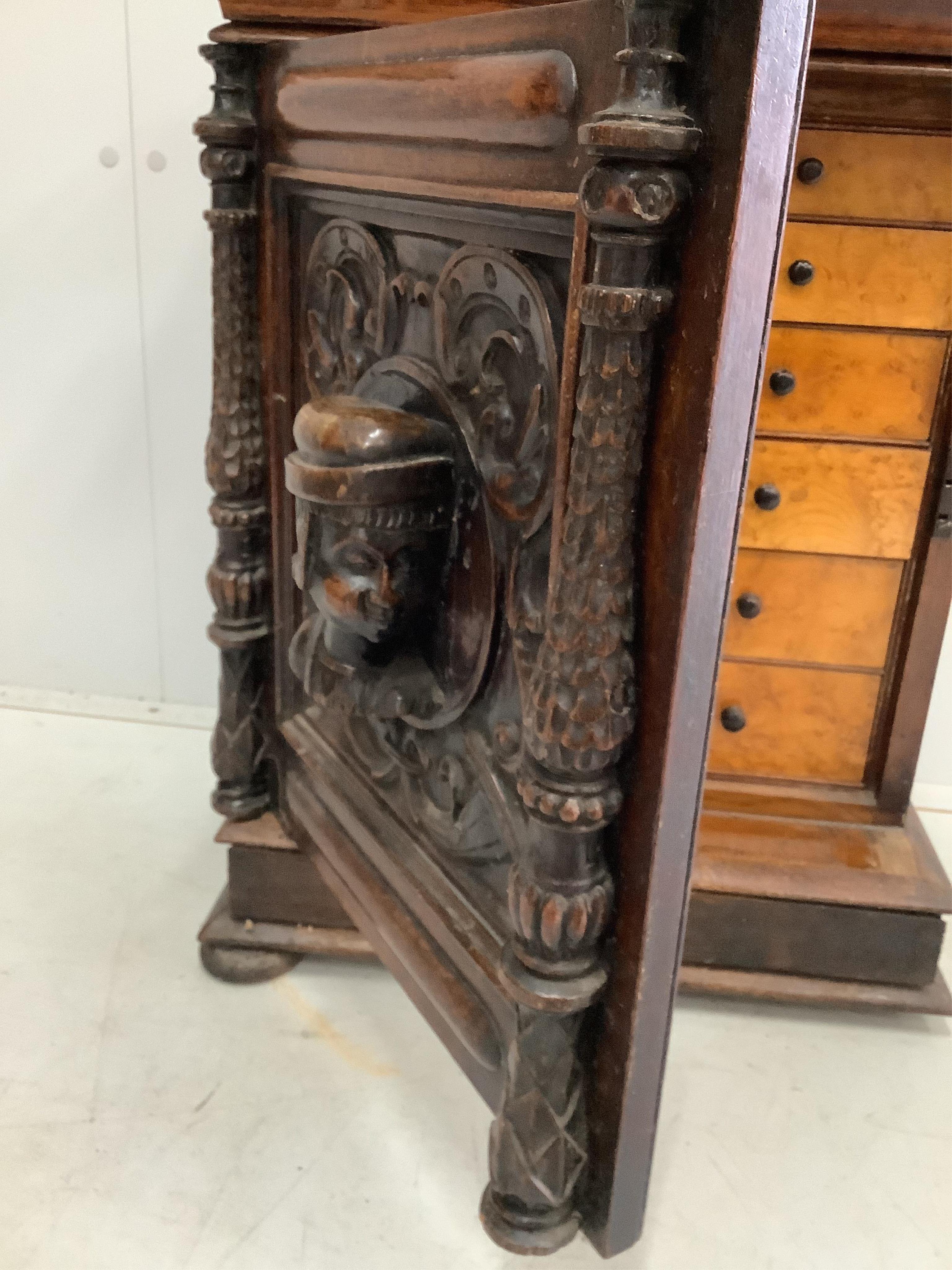 A small Italian carved oak and walnut collector's chest, fitted ten bird's eye maple faced drawers, width 49cm, depth 29cm, height 58cm. Condition - fair